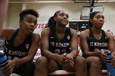 IU Kokomo women basketball players listen intently during a timeout.